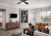 Thumbnail 3 of 37 - A modern living room with a brown leather couch and a wooden coffee table.