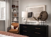 Thumbnail 8 of 37 - A modern bedroom with a brown chair and a white lamp.