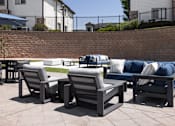 Thumbnail 37 of 37 - A set of outdoor furniture is arranged on a patio.