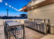 Thumbnail 23 of 30 - a kitchen with stainless steel appliances and a table