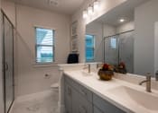 Thumbnail 13 of 28 - a bathroom with a large mirror and a sink and a shower