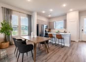Thumbnail 10 of 28 - an open kitchen and dining room with a table and chairs