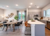 Thumbnail 9 of 28 - an open kitchen and dining area with a table and chairs