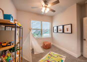 Thumbnail 15 of 28 - Bedroom with a tent in the corner and a ceiling fan