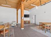 Thumbnail 19 of 22 - A room with a wooden floor and a white wall with a TV on it.