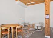 Thumbnail 18 of 22 - A room with a wooden table and chairs.