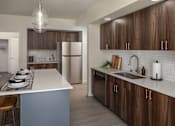 Thumbnail 6 of 34 - A modern kitchen with a white island and wooden cabinets.