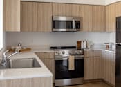 Thumbnail 1 of 27 - Modern kitchen with wooden cabinets and stainless steel appliances at The Arvon, Vancouver, 98662