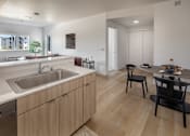 Thumbnail 5 of 27 - Modern kitchen with wooden cabinets and a white countertop at The Arvon, Vancouver, 98662