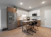 Thumbnail 63 of 68 - A kitchen with a table and chairs.