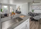 Thumbnail 8 of 38 - Kitchen and dining room with a table and chairs at Arbor Heights, 97224