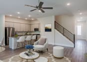 Thumbnail 15 of 31 - an open living room and kitchen with a spiral staircase