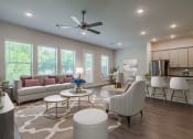 Thumbnail 16 of 31 - an open living room and kitchen with a ceiling fan
