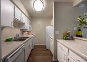Thumbnail 35 of 56 - full kitchen with white cabinets and counter tops and stainless steel appliances