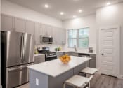 Thumbnail 19 of 28 - a kitchen with stainless steel appliances and a white counter top