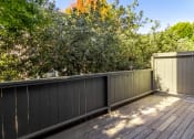 Thumbnail 15 of 15 - a backyard deck with a privacy fence and trees