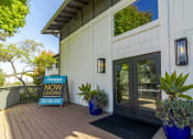 Thumbnail 4 of 15 - a white building with glass doors and a sign that reads lodging now leaving
