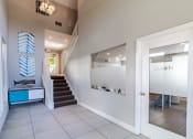 Thumbnail 7 of 15 - the entryway of a house with a staircase and a blue cabinet and a door