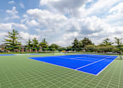 Thumbnail 15 of 19 - A tennis court with a blue surface and white lines.