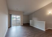 Thumbnail 9 of 19 - A room with a sliding glass door leading to a balcony.