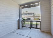 Thumbnail 13 of 32 - the view from the front porch of a home with a balcony and a driveway