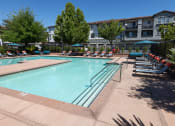 Thumbnail 4 of 22 - expansive pool with surrounding lounge chairs and umbrellas