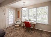 Thumbnail 9 of 39 - A room with a desk, chair, and window.