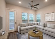 Thumbnail 20 of 28 - a living room with a couch and a coffee table