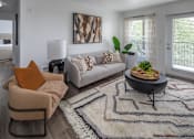 Thumbnail 1 of 23 - A living room with a couch, chair, and rug.