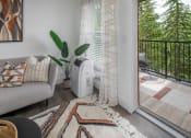 Thumbnail 4 of 38 - Living room with a couch and a heater next to a balcony at Arbor Heights, 97224