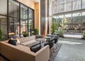 Thumbnail 32 of 44 - Living room filled with furniture and a large window at The Wyatt, Portland, OR, 97209