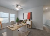 Thumbnail 14 of 31 - an office with a desk and a ceiling fan