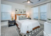 Thumbnail 21 of 29 - a bedroom with a large bed and three windows