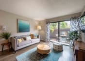 Thumbnail 32 of 56 - living room with couch and chair and sliding glass doors to patio
