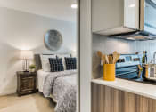Thumbnail 6 of 30 - a bedroom with a bed and a stove and a window