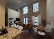 Thumbnail 7 of 28 - A living room with a brown table and white chairs.