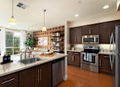 Thumbnail 2 of 28 - A modern kitchen with dark wood cabinets and stainless steel appliances.