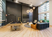 Thumbnail 20 of 28 - a living room with a pool table and a tv