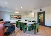 Thumbnail 19 of 28 - a dining room with a table and chairs and a couch