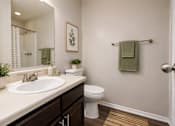 Thumbnail 55 of 55 - A bathroom with a white sink and toilet.
