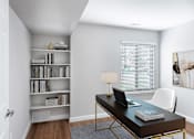Thumbnail 5 of 22 - A room with a desk, chair, and bookshelf.