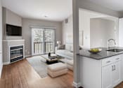 Thumbnail 6 of 22 - A modern living room with a fireplace and a kitchen area.