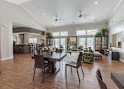 Thumbnail 10 of 22 - A modern dining room with a dark wood floor and a large table surrounded by chairs.