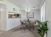 Thumbnail 16 of 22 - A dining room with a grey table and chairs.