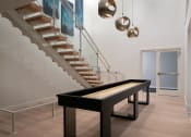 Thumbnail 19 of 30 - a ping pong table in a living room next to stairs