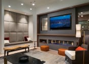 Thumbnail 28 of 30 - a large living room with a fireplace and a television