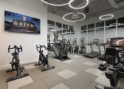 Thumbnail 24 of 30 - a gym with various exercise equipment and a tv on the wall