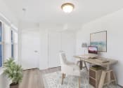 Thumbnail 35 of 51 - a home office with white walls and white doors and a desk with a white chair