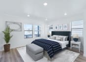 Thumbnail 36 of 51 - a white bedroom with a blue bed and a large potted plant