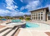 Thumbnail 18 of 41 - a swimming pool with a building in the background
